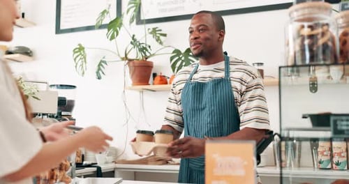 Barista, giving coffee cup and customer service at cafe counter with thank you