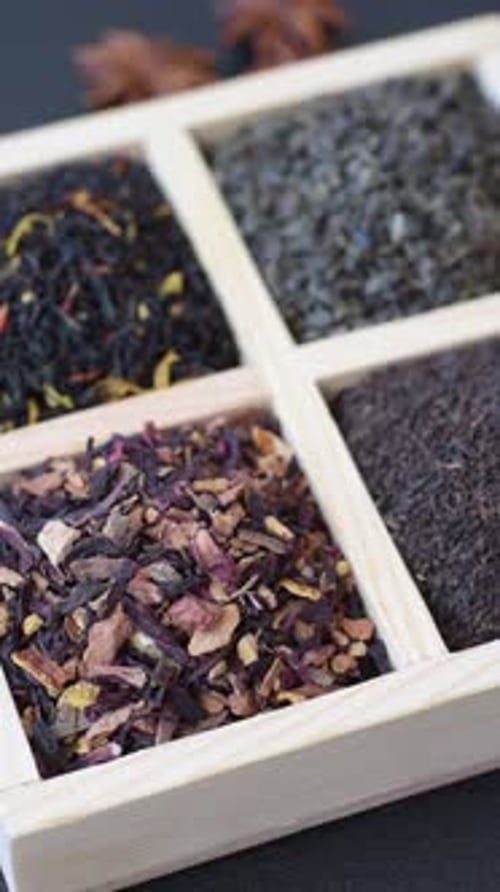 A box of various dry teas, black, green, herbal, and fruit. A set of different tea varieties