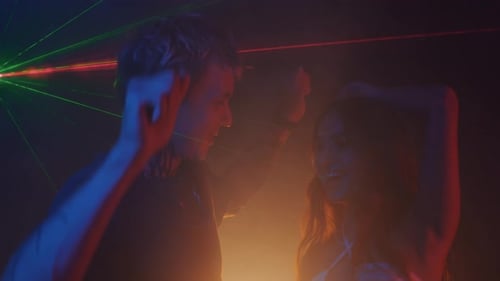 Couple Dancing at Nightclub with Laser Lighting