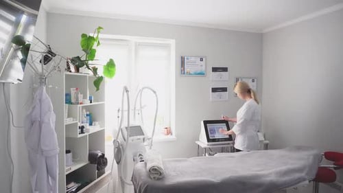 Woman Using Touch Screen Device in Medical Office