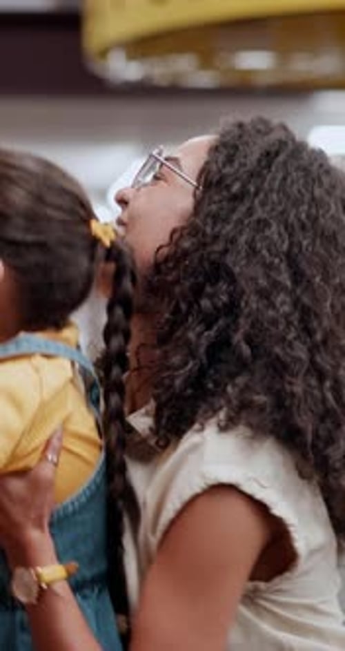 Mother, child and choose with book at library for story, knowledge or literature novel at store