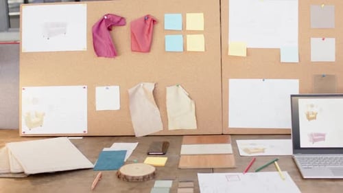 Interior design project, laptop and fabric samples on desk with mood board, at office