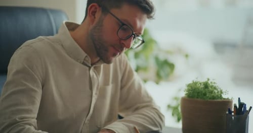Entrepreneur Preparing Business Documents at Office