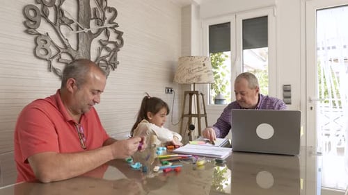 Child Playing with Father and Grandfather at Home