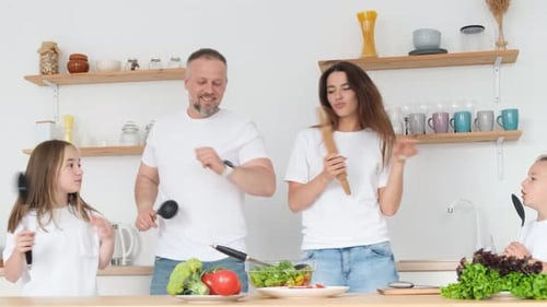 Happy Family Dancing and Singing in Kitchen