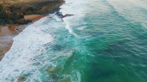 Drone View Rough Ocean Waves Crashing on Coastal Cliffs . Majestic