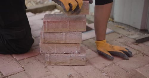 Construction Worker Piling Bricks