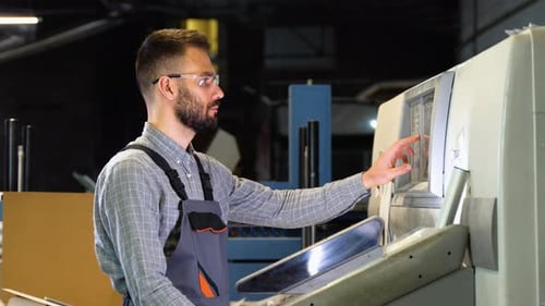 Technician Operator Checking Input and Output Status on Touchscreen Front Display Monitor Station in