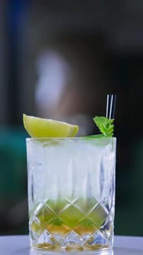 Refreshing Cocktail with Lime and Mint Garnish