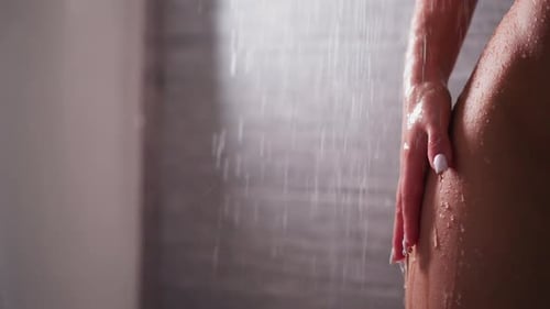 Woman's Body in Shower, Water Flowing Close Up