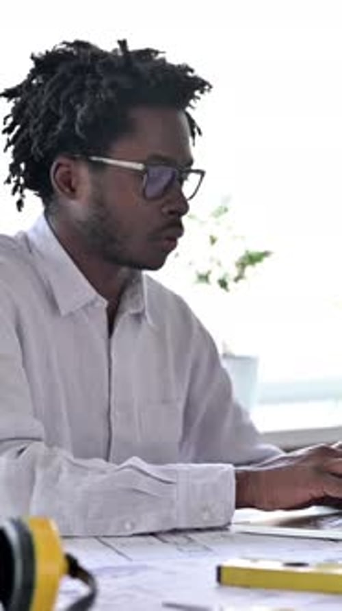 African Engineer Looking at Camera in Office, vertical video