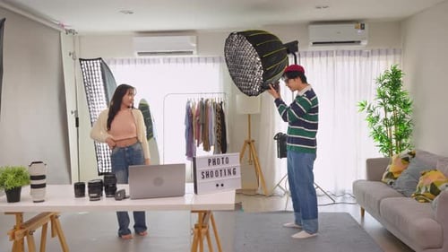 Asian beautiful woman model and cameraman working in photography studio.