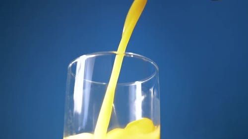 Juice Pouring into Glass in Close Up