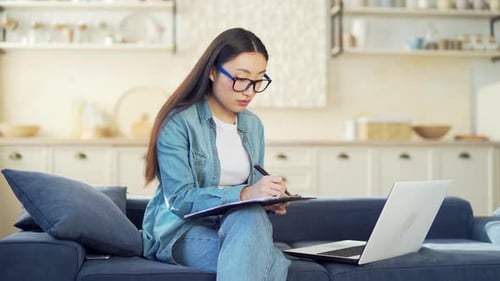 Young Adult Working on Laptop from Home