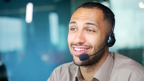 Close up. A corporate operator who works in customer support speaks on a video call using a laptop.