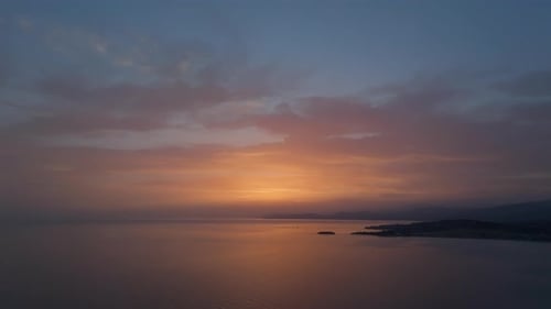 Sunset Ascent Over Tranquil Bay