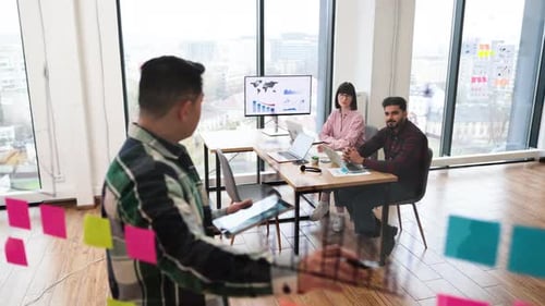 Business Team Meeting with Presentation and Technology in Office