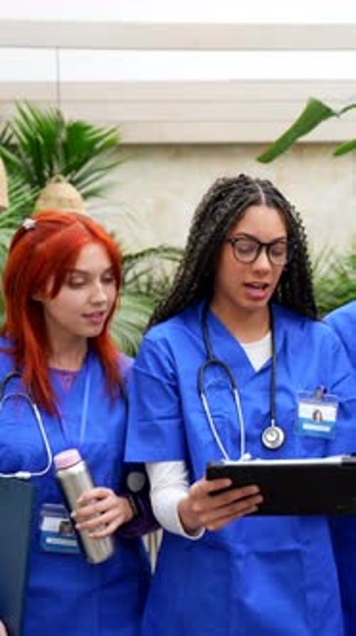 Young medical students discussing patient case on tablet
