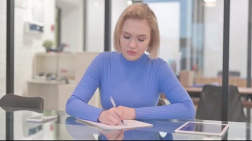 Young Woman Writing a Letter in Office