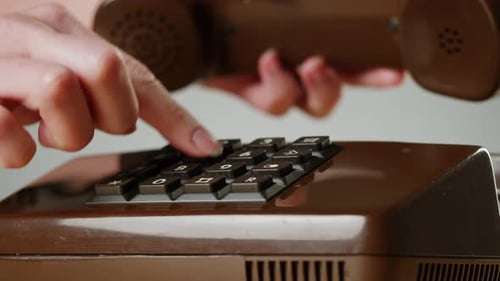 Hand Holding Old and Retro Telephone Vintage Phone Headset Isolated on Grey Studio Background Woman