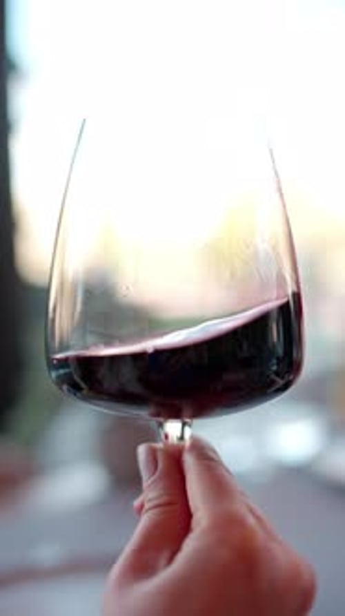 Hand Swirling Red Wine in Glass