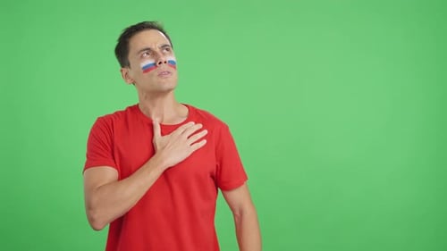 Man Listening to the Russia National Anthem with Solemnity