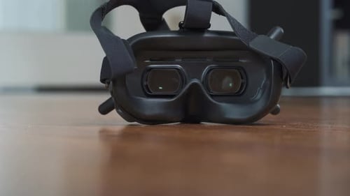 Close zoom shot of DJI Goggles on wooden parquet