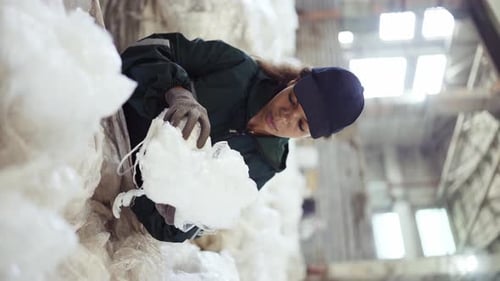 An AfricanAmerican Woman in a Special Uniform Sorts Polyethylene at a Waste Recycling Plant
