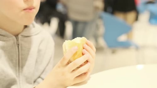 Cute Boy Eating Burger Close Up