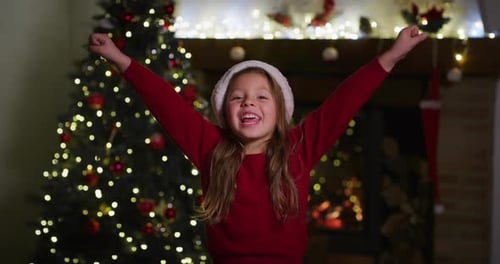 Excited Girl Celebrates Christmas in Cozy Home