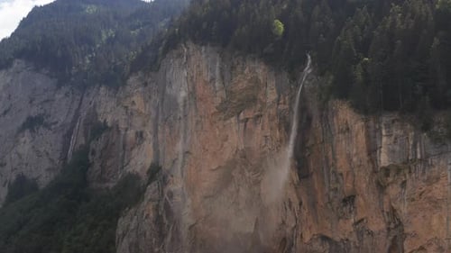 Aerial of beautiful waterfall falling of mountain ledge