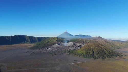 Drone shot of Mount Semeru Eruption Above Bromo Caldera, East Java, Indonesia. Sunny day with blue