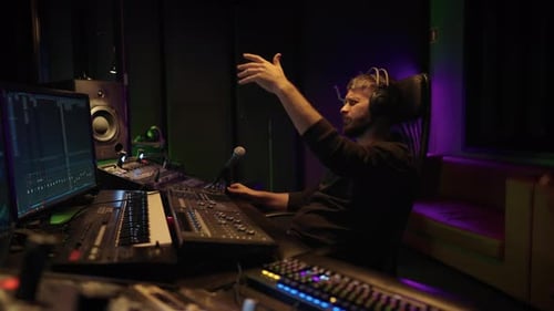 Soundman Working in Professional Record Studio Portrait of Man with Mixer Skilled Sound Director