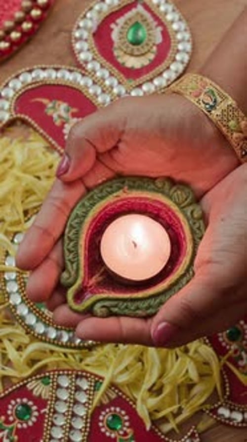 Glowing Diya Lamp Held During Diwali Celebration