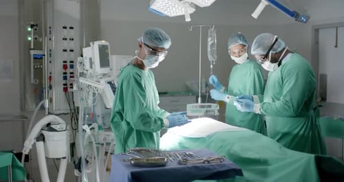 Surgeons Perform an Operation in Bright Surgical Room