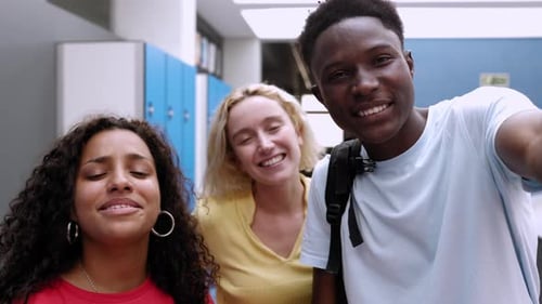 Three Young Adults Smiling in School Corridor