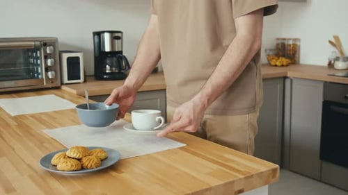 Man Prepares Simple Breakfast in Modern Kitchen