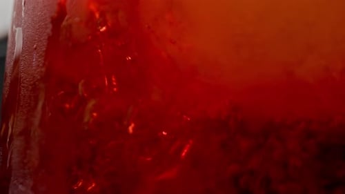 Close Up of Bubbles in Red Cocktail