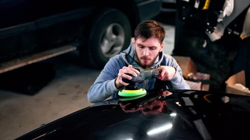 the Car Mechanic at a Service Station Doing the Final Polishing to Shine
