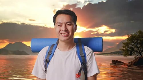 Close Up Of Asian Male Hiker Smiling To Camera At A Lake