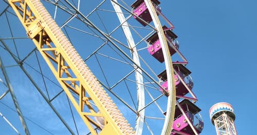 Colorful Ferris Wheel Against Clear Blue Sky