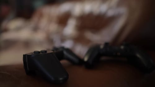 Hand Picks Up a Game Controller