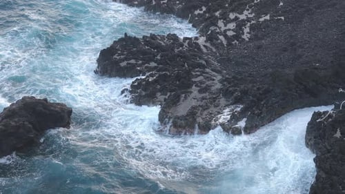 Waves Crashing on Rocky Coastline Aerial