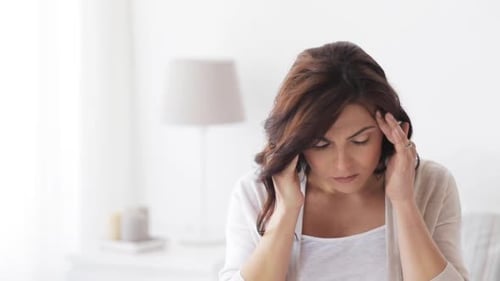 Woman Massaging Temples and Neck for Pain Relief