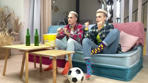 Friends Cheer While Watching Sports at Home