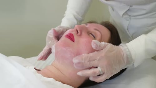 Woman Receives a Facial Massage at a Spa