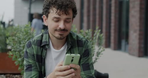 Man Using Smartphone Outdoors in the City