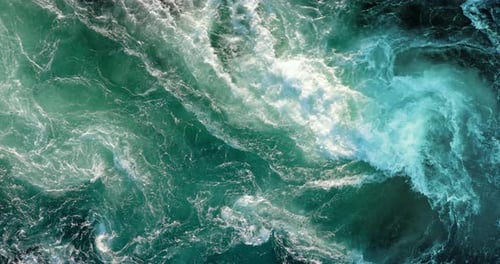 Blue waves of water of the river and the sea meet each other during high tide and low tide.