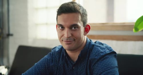 Portrait Of Young Male Professional Sitting On Couch In Modern Well Lit Office During The Day. Wi...