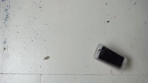 Broken Phone Dropped onto Painted White Floor